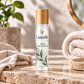 Lumerelle Facial Roll-On Serum in a frosted bottle with a wooden cap and green botanical label on a stone vanity.