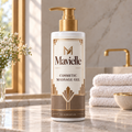 Mavielle Cosmetic Massage Gel in a white gold-pump bottle with bronze geometric packaging on a sunlit bathroom counter.